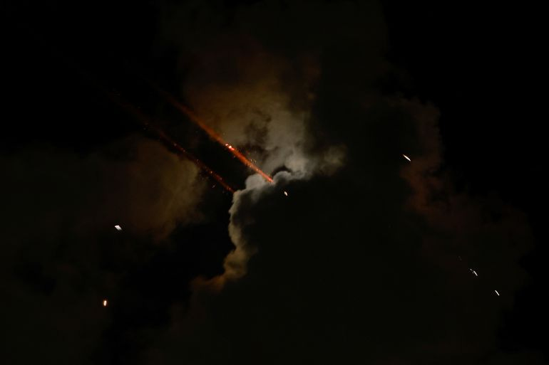 Rockets fly in the sky, amid cross-border hostilities between Hezbollah and Israel, as seen from Tel Aviv