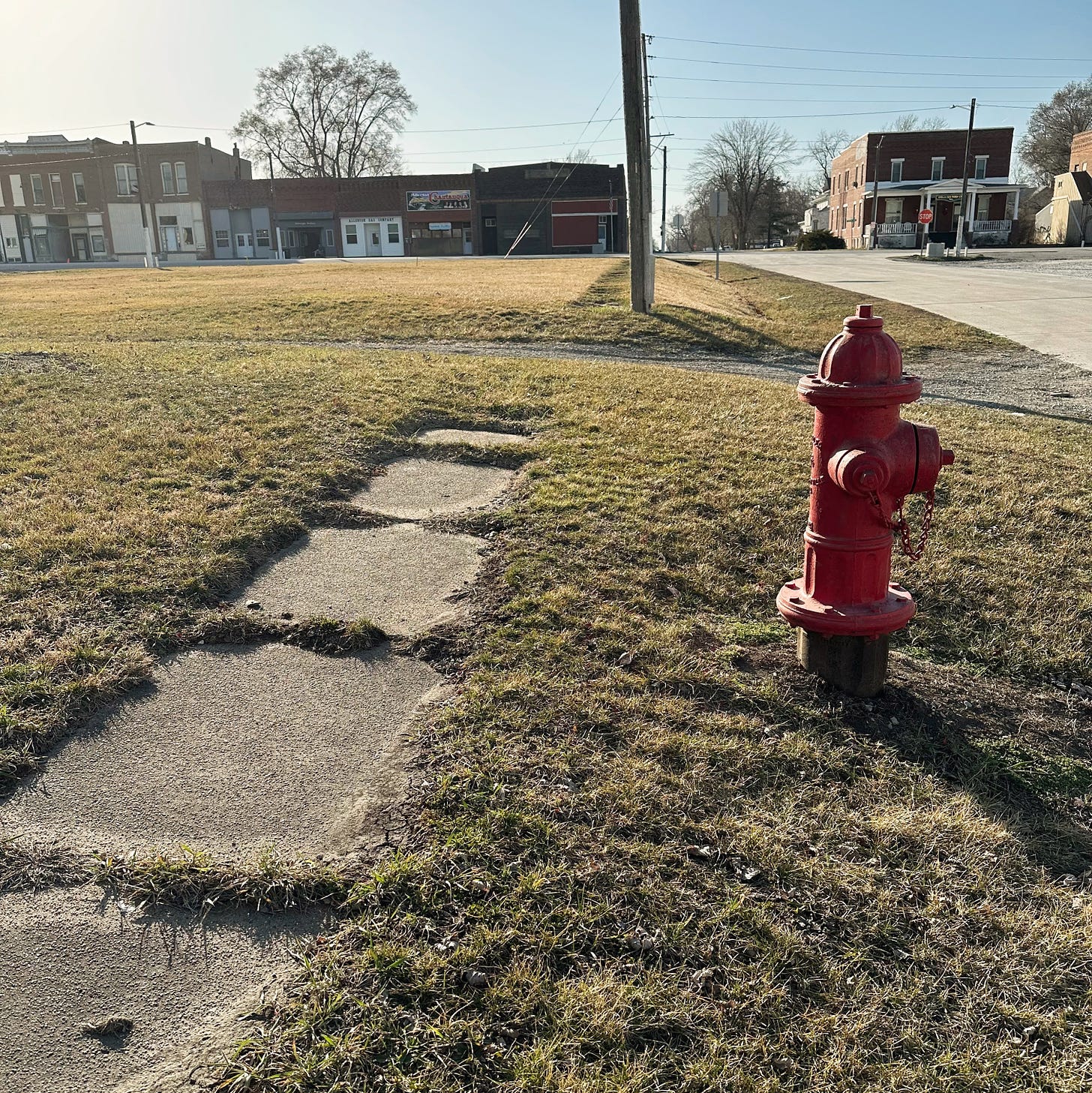 A decayed sidewalk and a fire hydrant