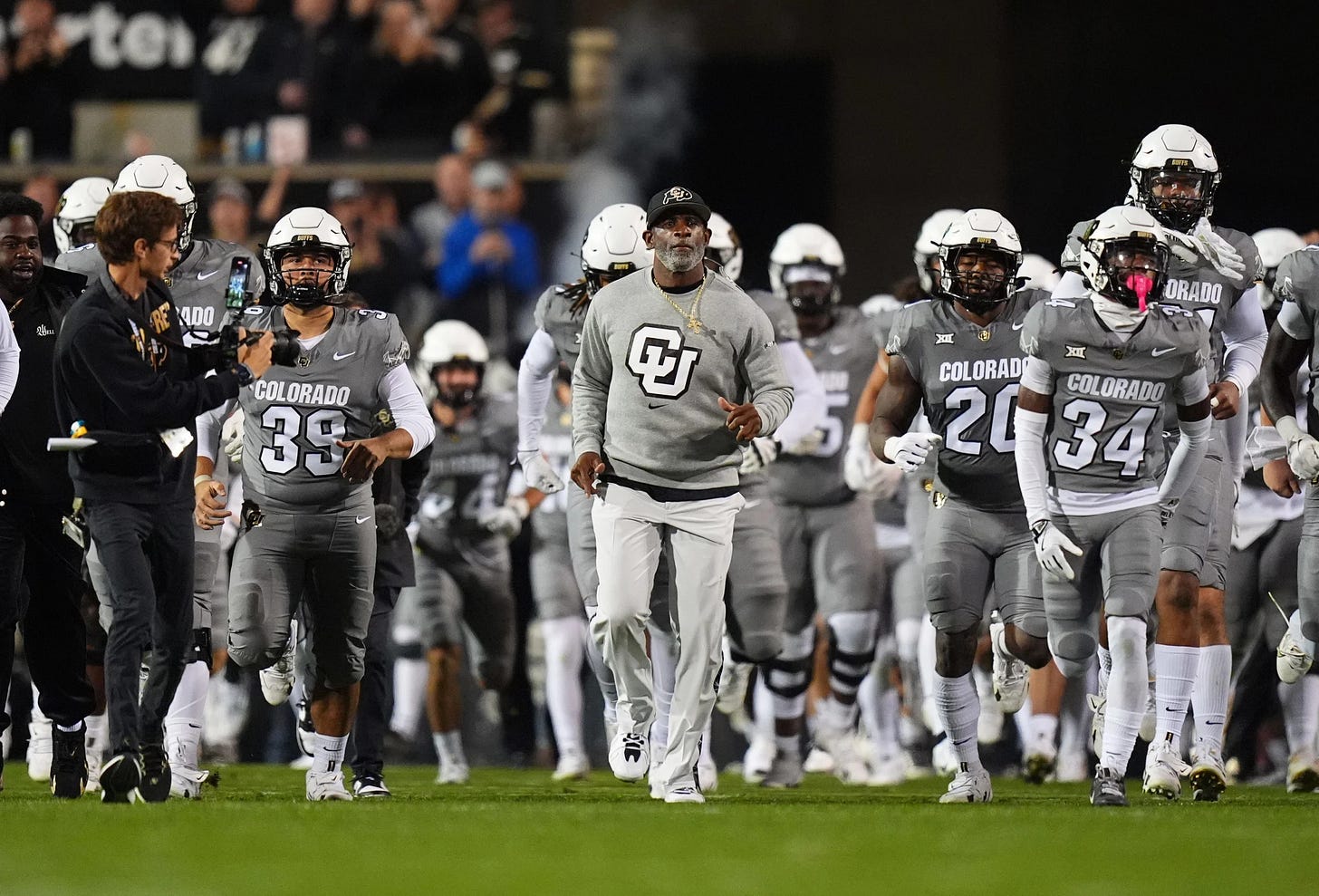 Oct 26, 2024; Boulder, Colorado, USA; Colorado Buffaloes head coach Deion Sanders leads out the team before the game against the Cincinnati Bearcats at Folsom Field. Mandatory Credit: Ron Chenoy-Imagn Images