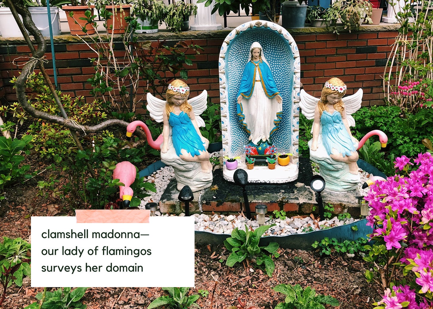 Photo of a yard in which a statue of the Virgin Mary is surrounded by angels, flamingos, and flowers. Text reads: "clamshell madonna— / our lady of flamingos / surveys her domain"