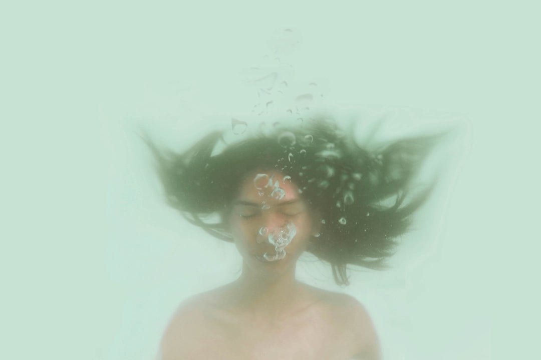 woman breathing underwater woman breathing underwater