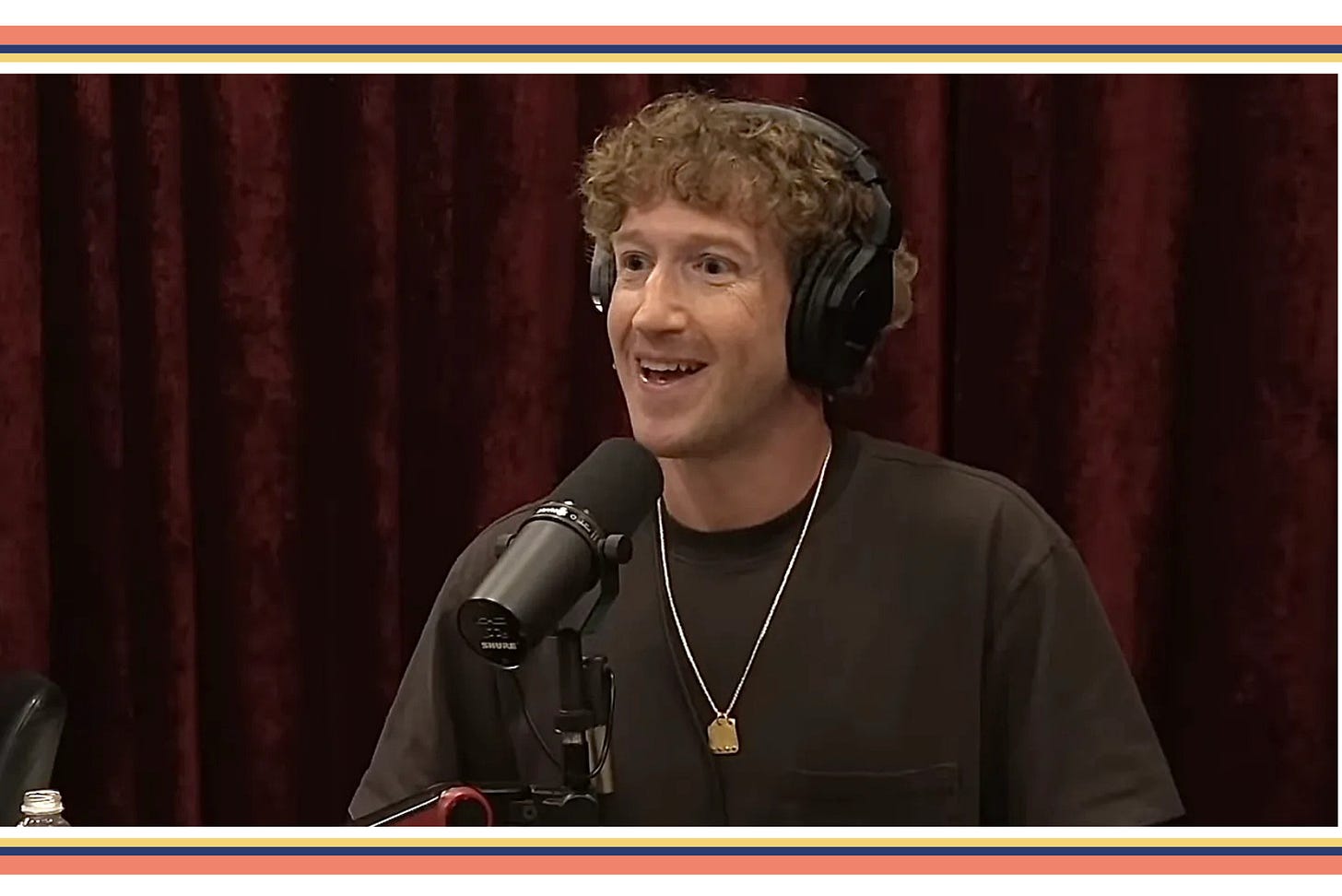 Mark Zuckerberg grinning and wearing a very big chain