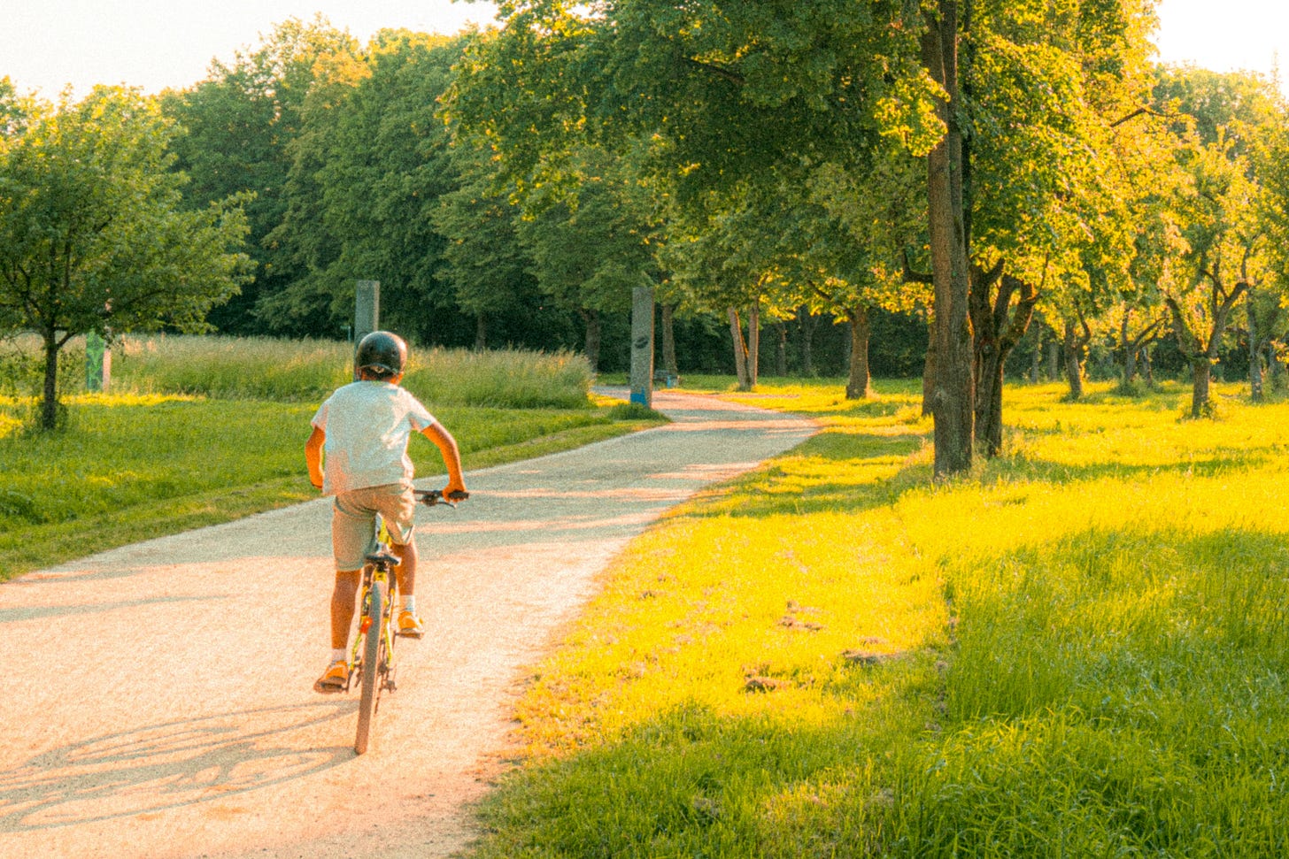 Child riding bike down country road Child riding bike down country road