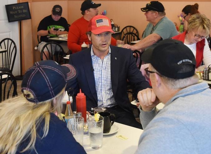 Pete Hegseth, co-host of FOX & Friends, sitting at a table with diners at Goolee's Grill, discussing Joe Biden's presidential run.