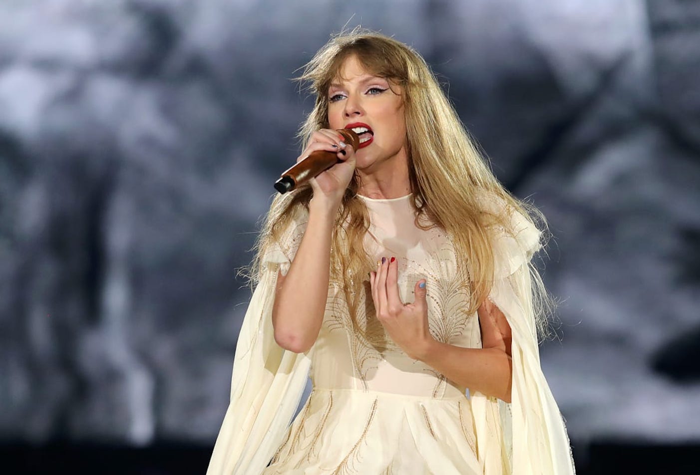 Taylor Swift singing during the folklore set on Eras Tour.