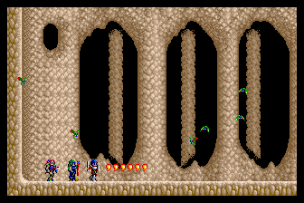 A screenshot of the PC Engine release of Sorcerian, featuring three party members in a cave with some massive rock formations in the background.