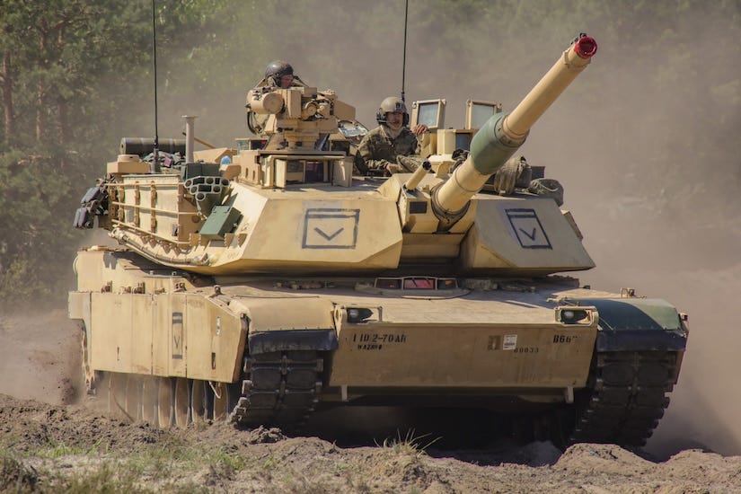 A tank maneuvers in a field.
