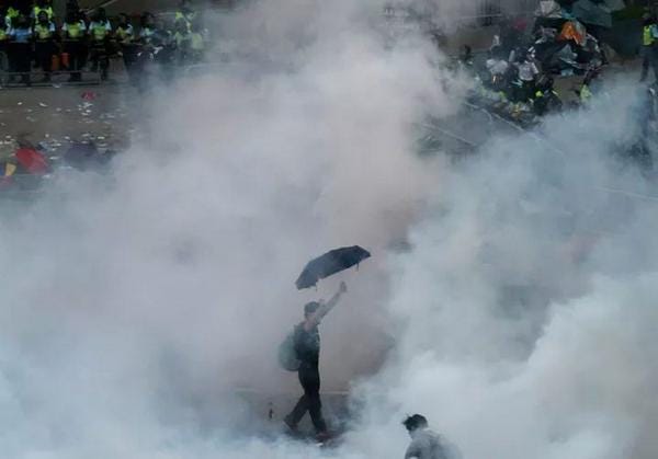 Pro-democracy protestor engulfed by tear gas. Hong Kong, September 28, 2014. Pro-democracy protestor engulfed by tear gas. Hong Kong, September 28, 2014.