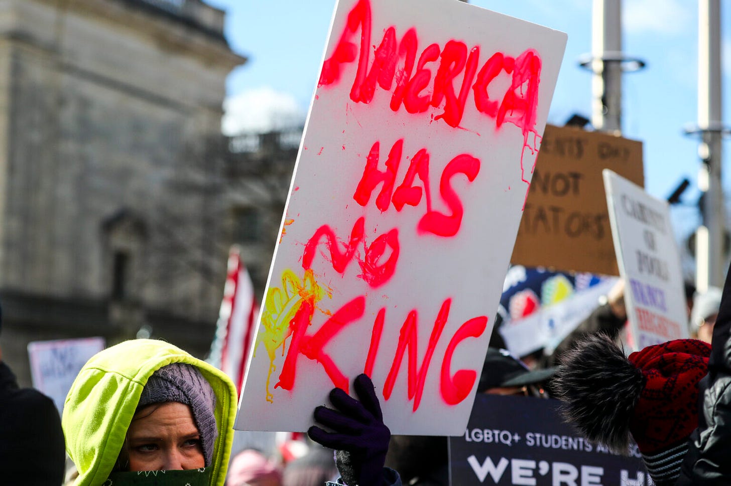This wire-service photo, taken by Dana DiFilippo of the New Jersey Monitor newspaper, shows a protestor holding a sign with the words "America Has No King" spray-painted in red. This photo was taken on 17 February 2025 at Trenton, New Jersey's State House as part of the "Not My Presidents' Day" protests held all around the United States. This wire-service photo, taken by Dana DiFilippo of the New Jersey Monitor newspaper, shows a protestor holding a sign with the words "America Has No King" spray-painted in red. This photo was taken on 17 February 2025 at Trenton, New Jersey's State House as part of the "Not My Presidents' Day" protests held all around the United States.
