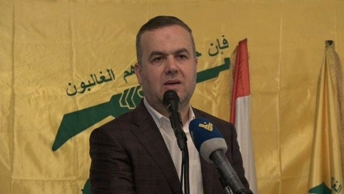 Loyalty to the Resistance Bloc MP, Hassan Fadlallah, speaking at a press conference with the flags of the Islamic Resistance and Lebanon displayed behind him-undated- (social media)