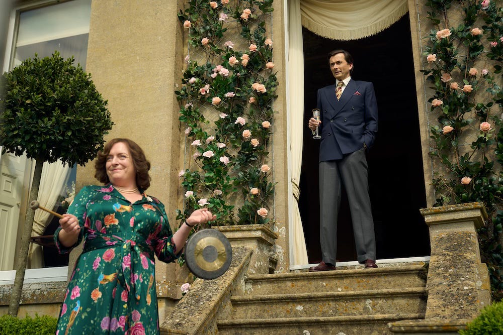 Claire Rushbrook bangs a gong as David Tennant looks on