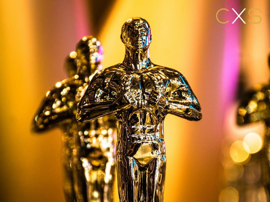 a number of oscar statues on a table a number of oscar statues on a table