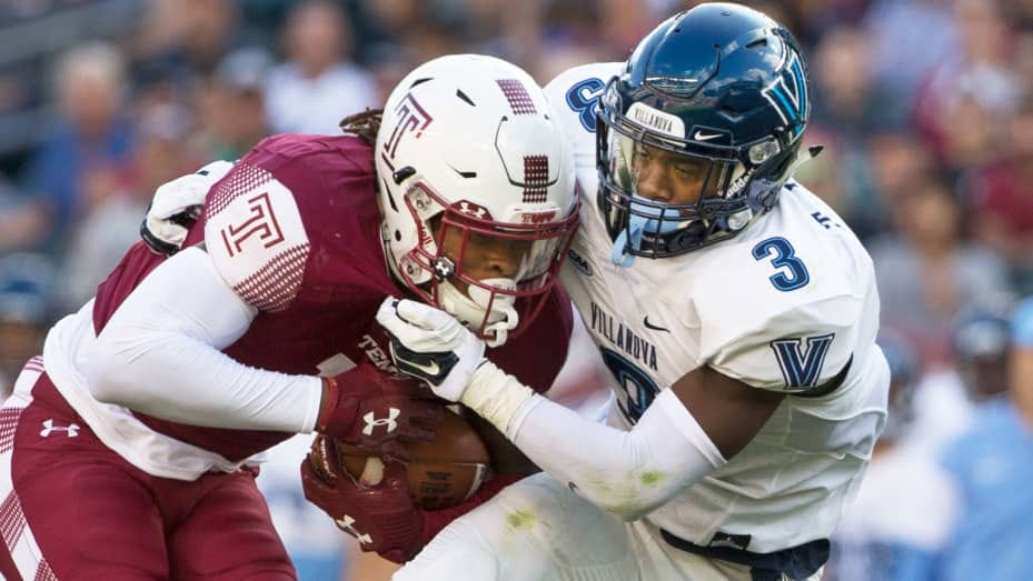 Isaiah Wright #13 of the Temple Owls runs with the ball and is tackled by Trey Johnson #3 of the Villanova Wildcats at Lincoln Financial Field on September 9, 2017 in Philadelphia.