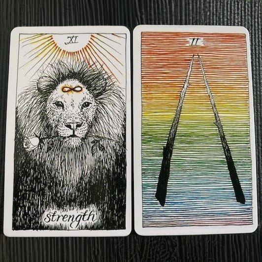 tarot cards showing a lion and two wands