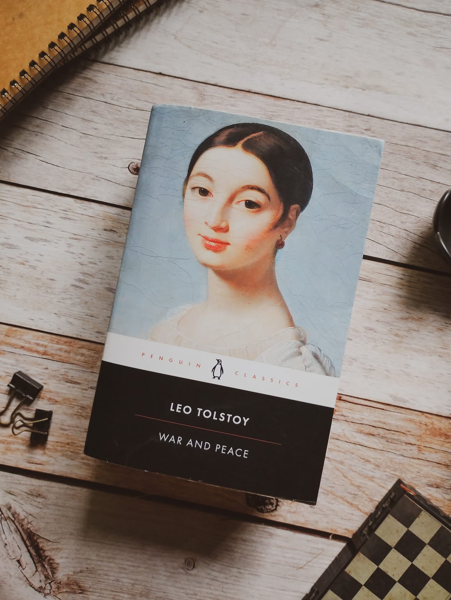 Penguin black classics, War and Peace by Leo Tolstoy, on a wooden table