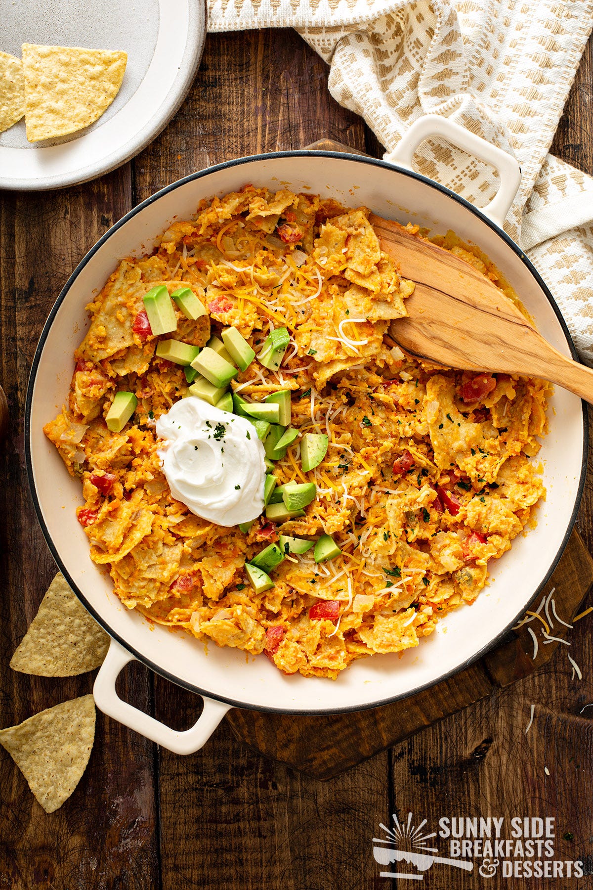 Sweet potato migas in a pan with toppings.