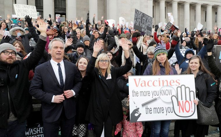 Robert Kennedy Jr., left, stands with participants at a rally held in opposition to a bill that would remove parents' ability to opt their school-age children out of the combined measles, mumps and rubella vaccine on Feb. 8, 2019, at the Capitol in Olympia, Wash.