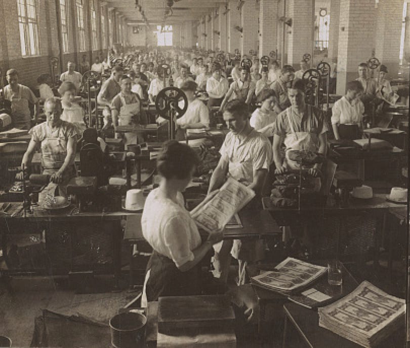 A factory floor in 1910 with workers printing and inspecting paper money.