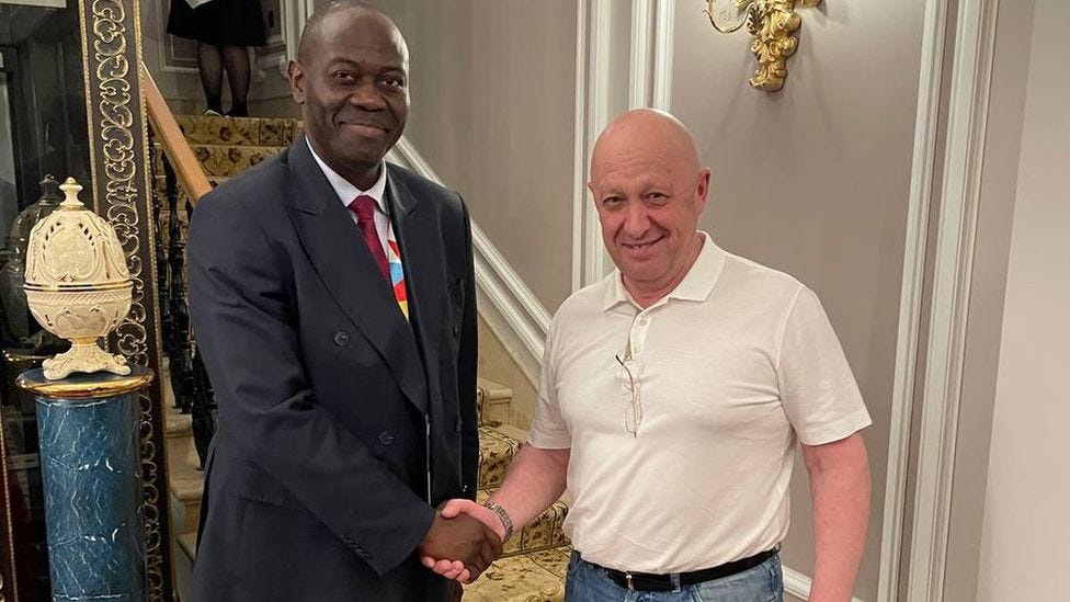 Ambassador Freddy Mapouka shakes hands with Yevgeny Prigozhin