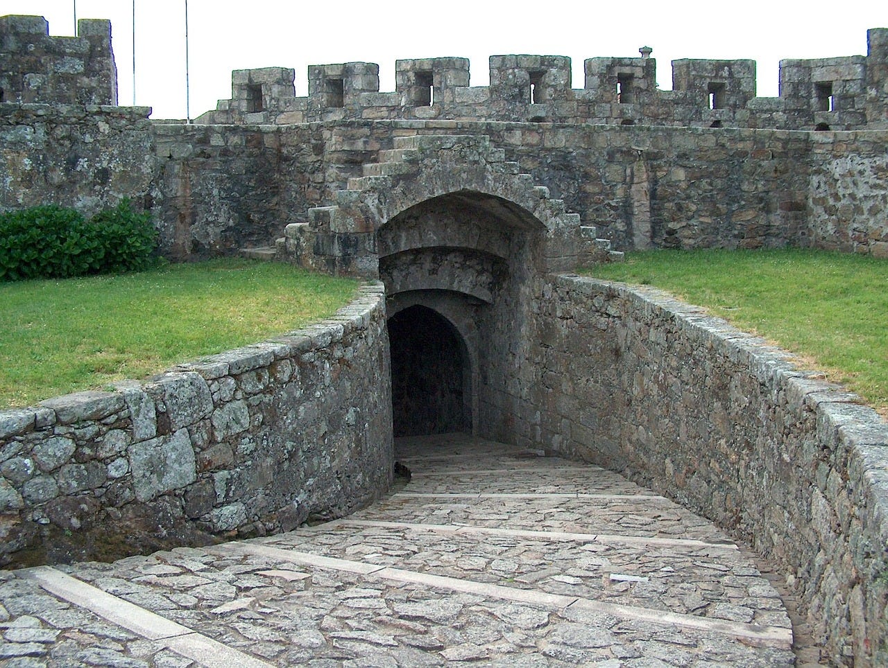 Winding path leading down to an underground castle door