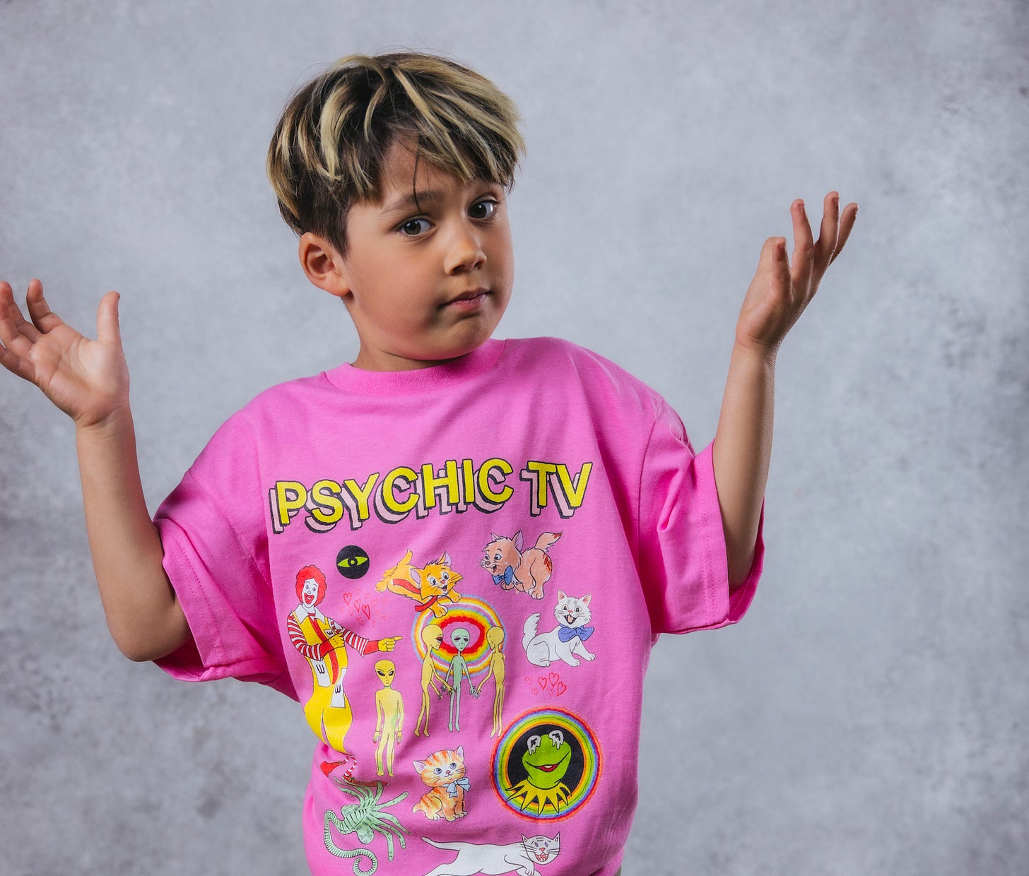 Pink shirt with the words "Psychic TV" at the top and illustrations of Kermit and cats and Ronald McDonald with upside down M's