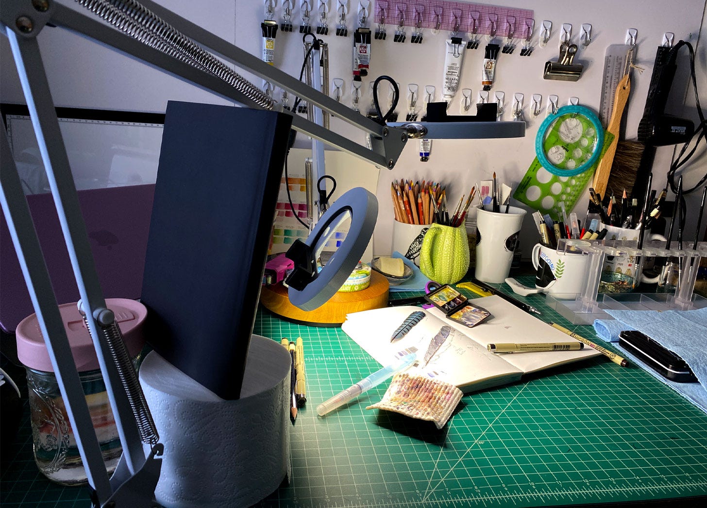 illustrator's desk during filming with lights and a makeshift boom illustrator's desk during filming with lights and a makeshift boom
