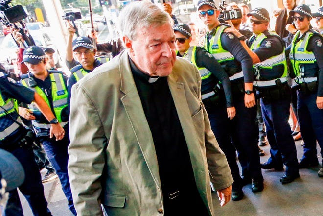 Cardinal George Pell arrives for a hearing at an Australian court in Melbourne, Australia, in 2018. Pell, who was the most senior Catholic cleric to be convicted of child sex abuse before his convictions were later overturned, died Tuesday. He was 81.