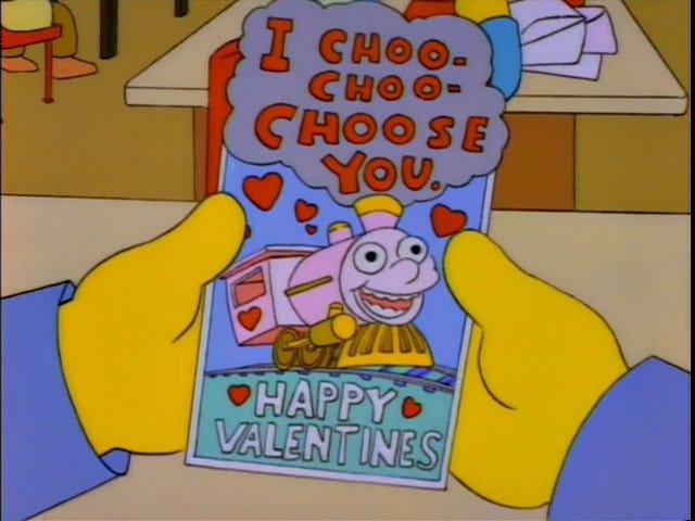 Ralph Wiggum getting a Valentine that says "I CHOO-CHOO-CHOOSE YOU HAPPY VALENTINES"