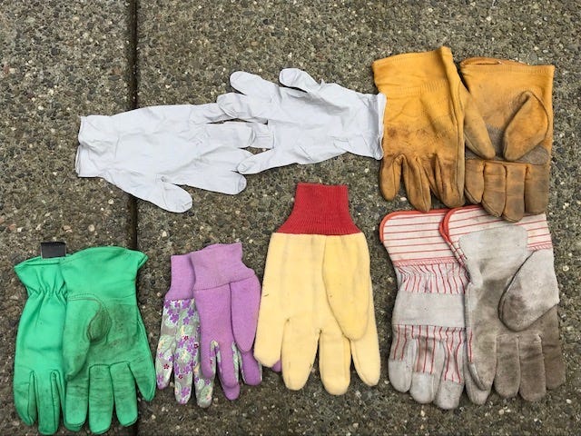 A group of gloves on a concrete surface

Description automatically generated