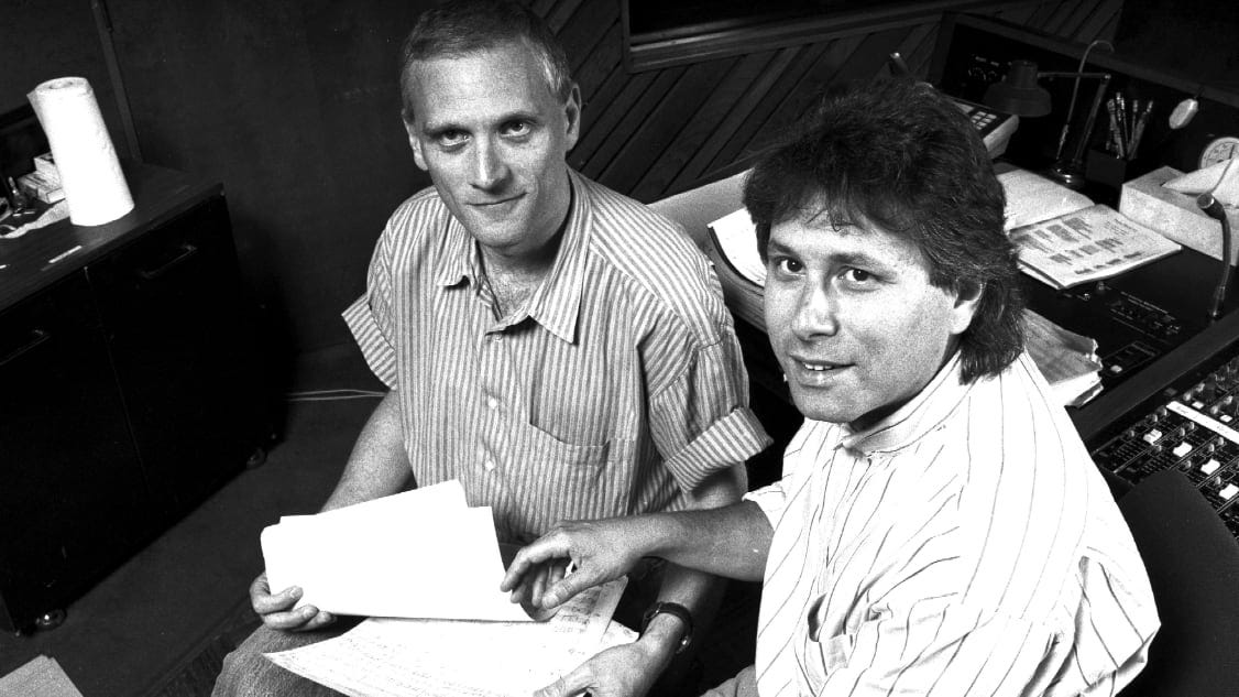 Howard Ashman sitting next to Alan Menken.