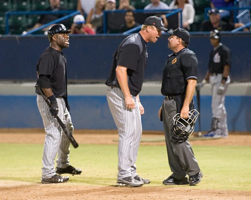 Player and manager arguing with an umpire