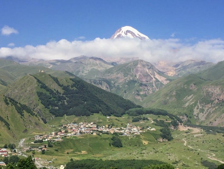 Mount Kazbek with Gergeti Trinity Church on top of the lower left hill.