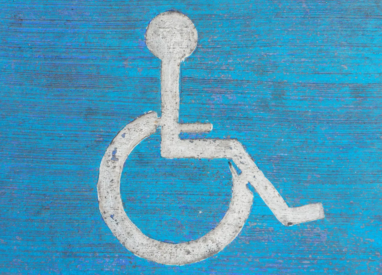 Wheelchair symbol painted on cement surface