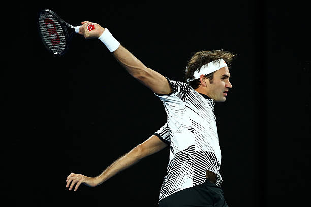 Roger Federer of Switzerland plays a backhand in his third round match against Thomas Berdych of the Czech Republic on day five of the 2017...