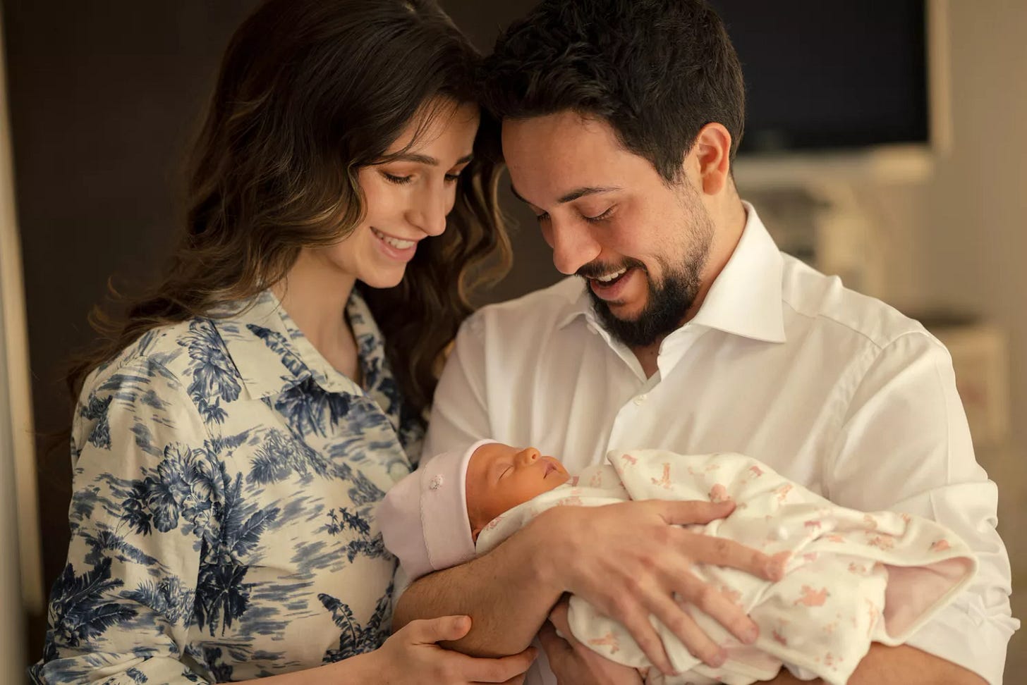 Prince Hussein holds his newborn daughter Princess Iman, with his wife, Princess Rajwa
