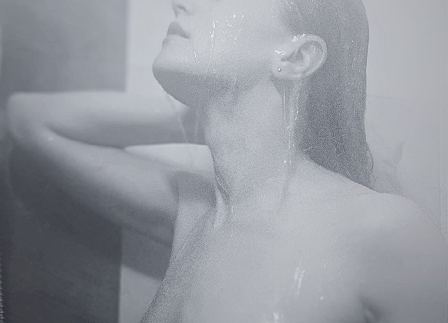 naked woman under shower, face closeup, running water, black and white image