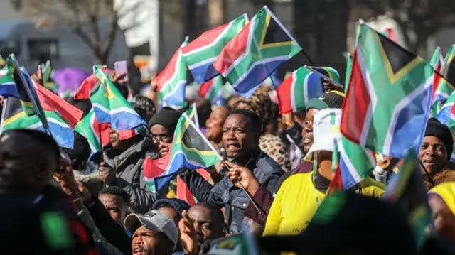 Supporters outside Union Buildings wave South African flags
