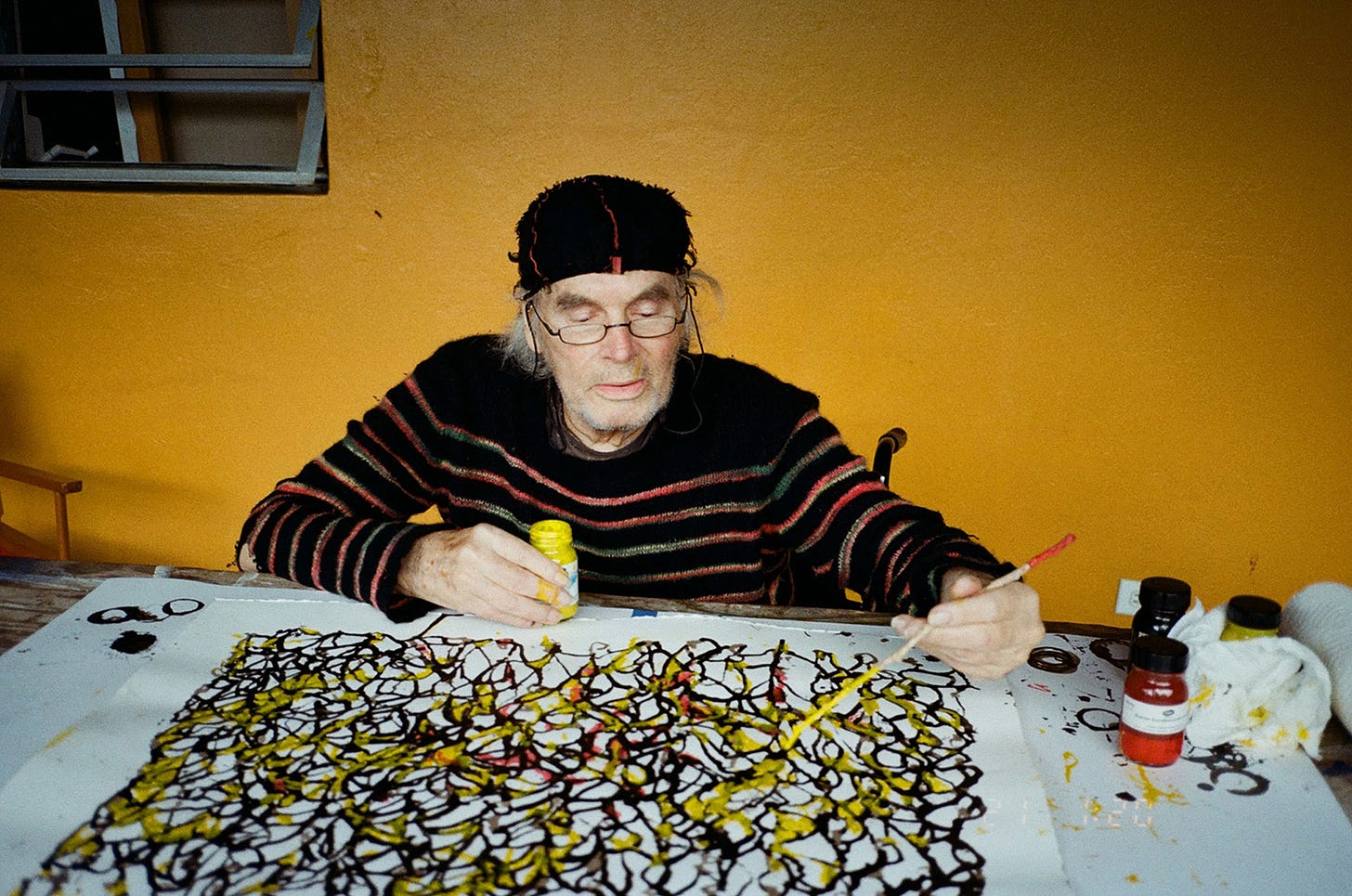 Brice Marden working in his Nevis, West Indies studio, 2023 [© 2025 Estate of Brice Marden / ARS, New York. Photo: Mirabelle Marden. Courtesy Mirabelle Marden and Gagosian]. Exhibition: Brice Marden: Works on Paper, Gagosian, Paris, June 14 – August 2, 2025