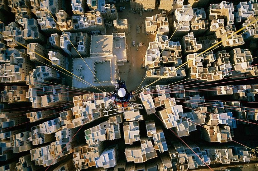 George Steinmetz flies a paraglider over Shibam, Yemen