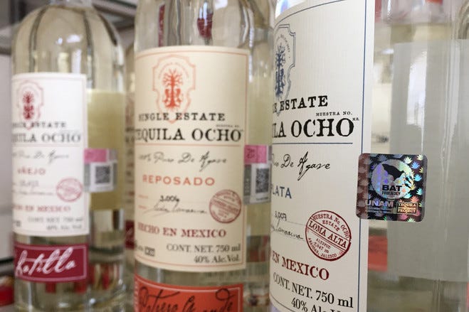 A bottle of Tequila Ocho displaying the Bat Friendly Certification logo, emphasizing its commitment to sustainable and environmentally friendly practices. A bottle of Tequila Ocho displaying the Bat Friendly Certification logo, emphasizing its commitment to sustainable and environmentally friendly practices.