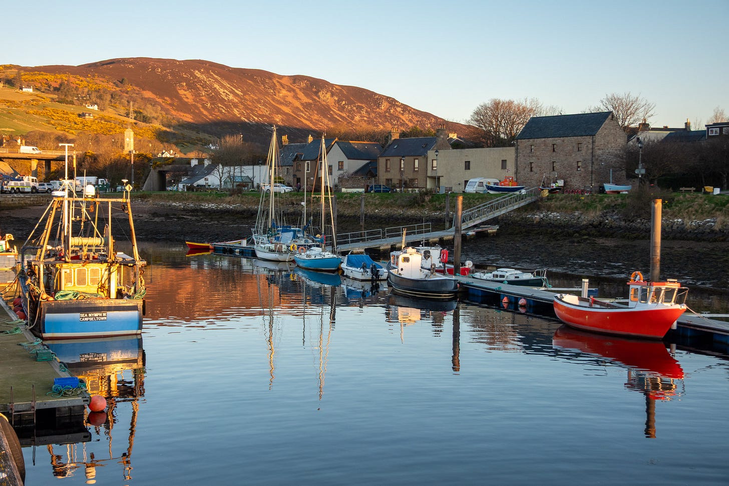 The rising sun illuminates Helmsdale Harbour © Felicity Martin