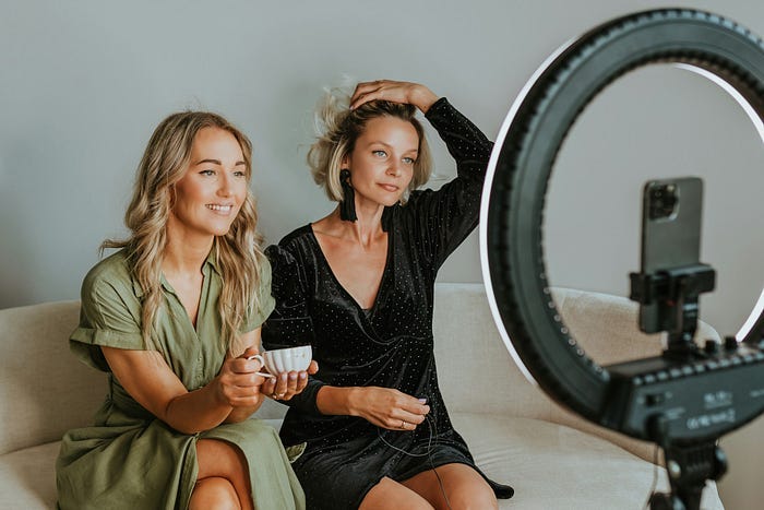 Two women filming a YouTube video. Two women filming a YouTube video.