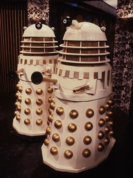 Two Necros-style Daleks in a shot from Revelation of the Daleks (1985)