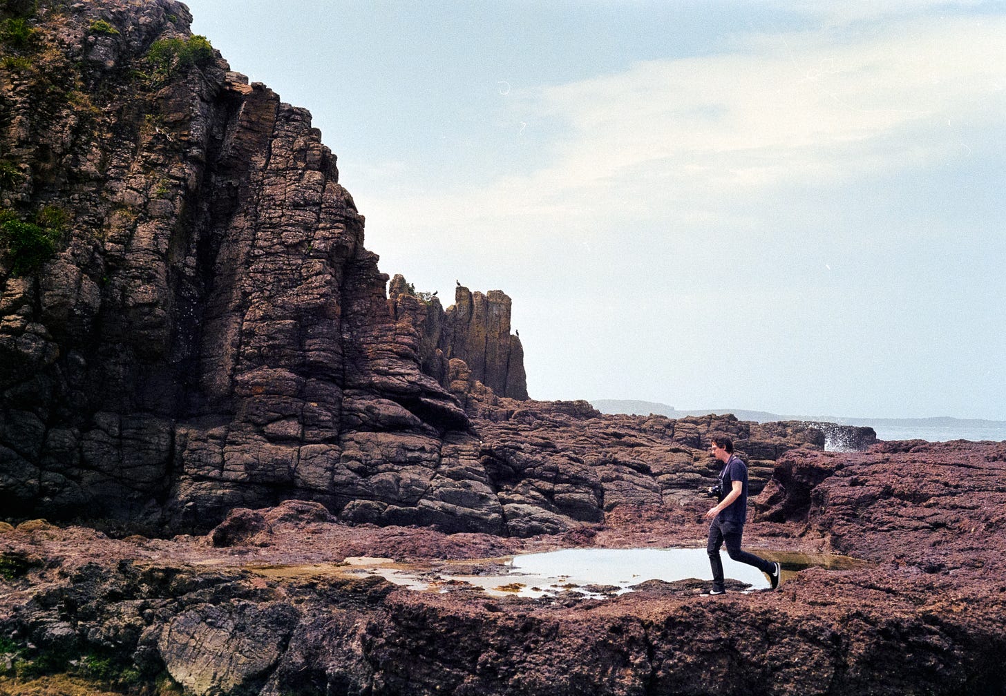A landscape of Cathedral Rocks with Jordan running along the rock edge