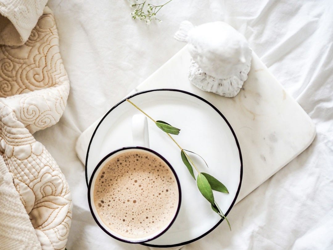 white teacup filled with coffee
