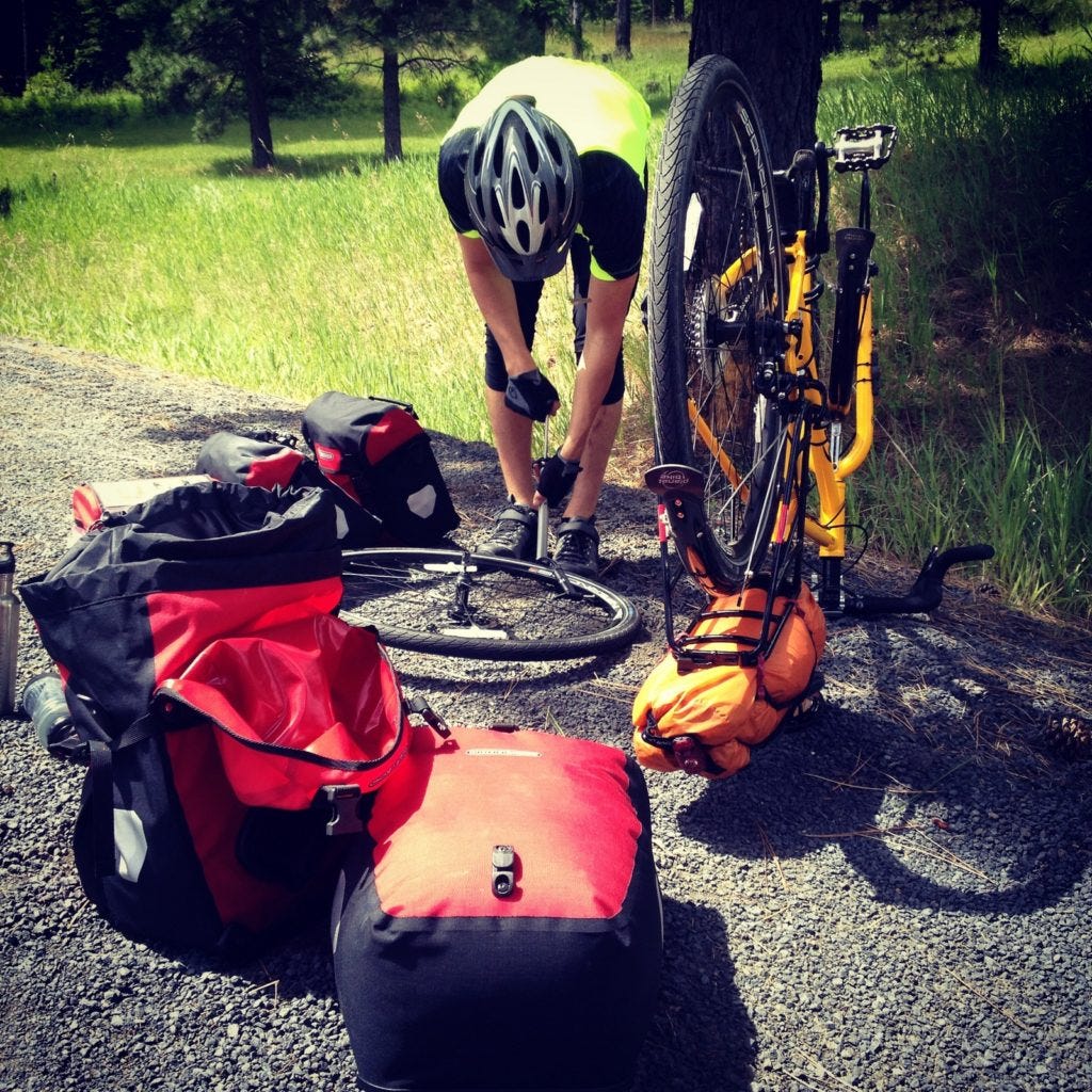 The undesired but gonna-happen side of bike touring. Two miles in, my front tube exploded like a shotgun blast! (C photo)