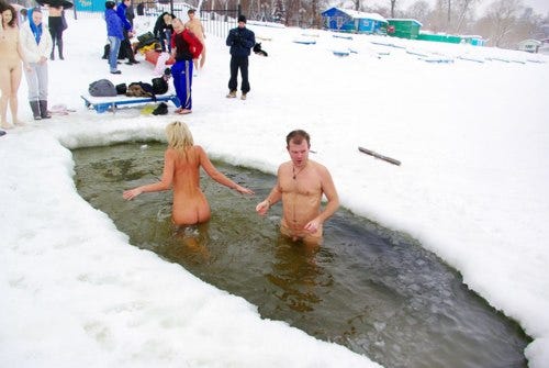 A nudist couple in a cold water pond