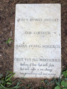 Shelley's gravestone in the Cimitero Acattolico in Rome; phrases from "Ariel's Song" in Shakespeare's The Tempest appear below