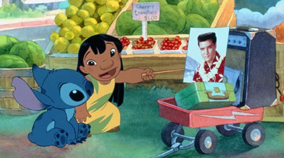 Lilo showing Stitch a photograph of Elvis in Lilo & Stitch.
