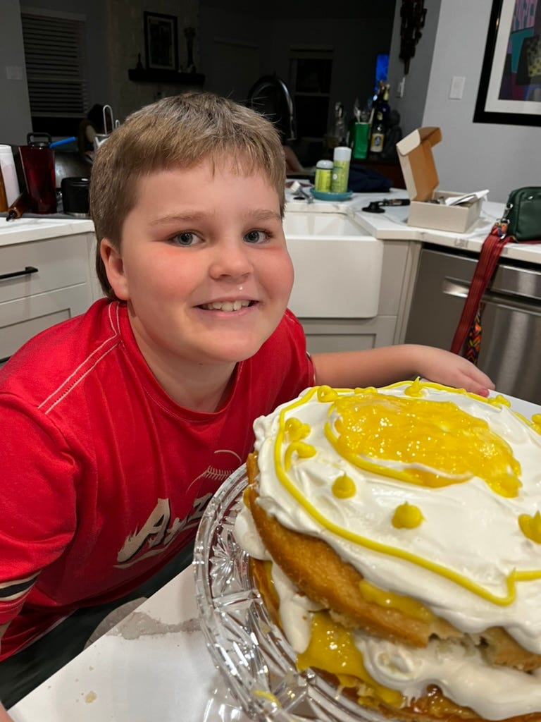cute kid smiles with sloppy lemon cake
